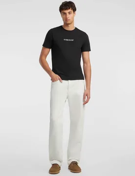 T-shirt Jeans nera in cotone con logo ricamato sul petto - Guess - FashionsVida