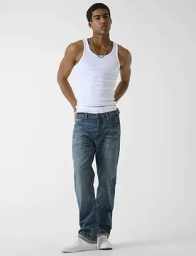 Jeans lavaggio medio sabbiato in cotone con patch logo - Guess - FashionsVida
