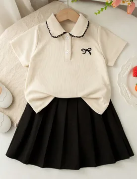 Piezas Conjunto de blusa de manga corta con cuello de botones y estampado de moño, y falda plisada para niñas, estilo casual de verano - Shein - FashionsVida