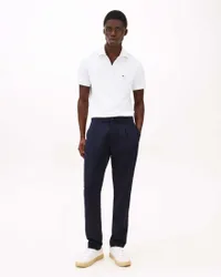 Polo bianca in misto cotone con zip e logo ricamato
