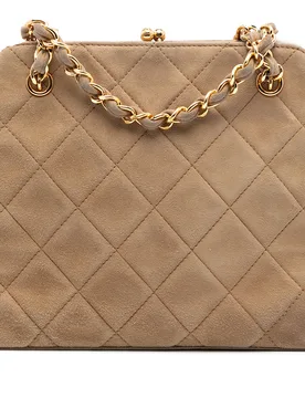 CC Quilted Suede Kiss Lock Handbag - Chanel - FashionsVida
