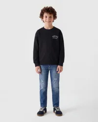 Jeans slim fit dal lavaggio medio in misto cotone con rotture