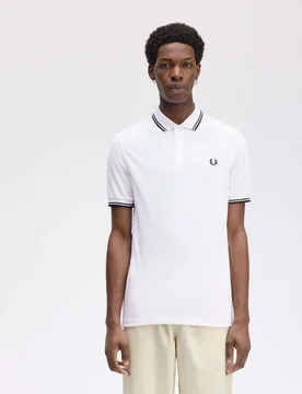 Polo bianca mezza manica con bordino nero - Fred perry - FashionsVida